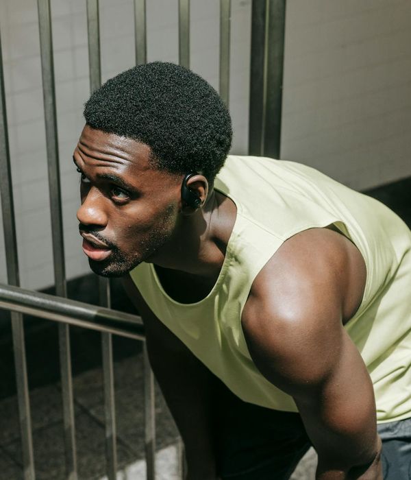 Man performing a strength exercise in a modern gym.